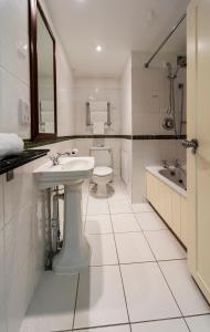 a white bathroom with a sink and a toilet at The Old Ship Hotel in Brighton & Hove