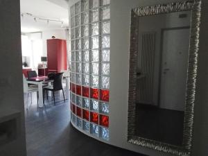 a mirror on a wall next to a dining room at Appartamento Guido in Monfalcone +4 photos