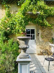 a stone vase sitting in front of a house at Chateau de Fajac la Selve in Pech-Luna