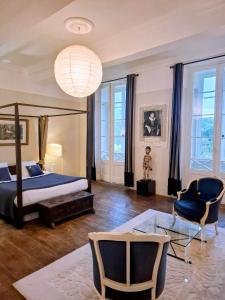 a bedroom with a bed and a table and chairs at Chateau de Fajac la Selve in Pech-Luna