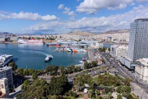 a view of a city with boats in the water at Piraeus PortView Apt in Piraeus