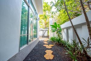 a walkway with stepping stones on the side of a building at BrightFly Pool Villa in Pattaya Central