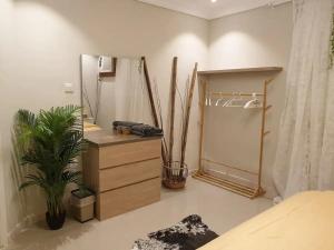 a bedroom with a dresser and a mirror at Mall of Islamabad Signature Apartments-F7 in Islamabad
