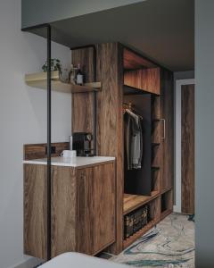 a bathroom with a wooden cabinet with a sink at Le Méridien Paris Arc De Triomphe in Paris