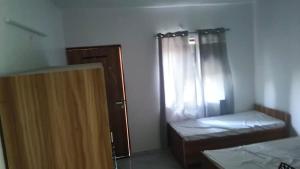 a small room with a bed and a window at TGH Expo Mart in Greater Noida