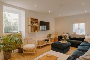 a living room with a blue couch and a chair at 4 Bed in Lobb oc-s33517 in Georgeham