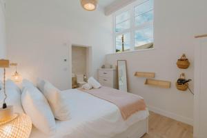 a white bedroom with a bed and a window at 4 Bed in Lobb oc-s33517 in Georgeham +21 photos