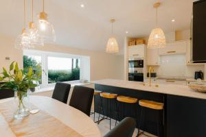 a kitchen with a table and chairs and a counter at 4 Bed in Lobb oc-s33517 in Georgeham