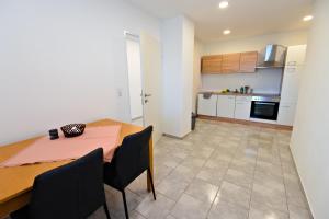 a kitchen and dining room with a table and chairs at Ferienwohnung Zirbitzblick in Fohnsdorf +8 photos