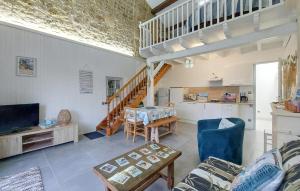 a living room with a couch and a table at 1 Bedroom Cozy Home In La-Gripperie-Saint-Sym in La-Gripperie-Saint-Symphorien +14 photos