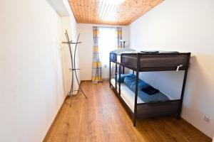 a room with two bunk beds and a wooden floor at Ferienwohnung Zirbitzblick in Fohnsdorf