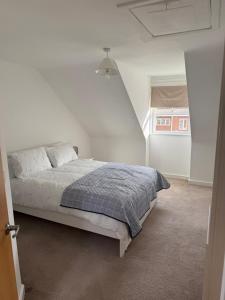 a bedroom with a bed in a white room at Modern 3-Bedroom Home 3 Minutes from Biggin Hill Airport - Secure Gated Community in Biggin Hill