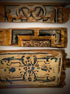 a group of wooden boxes on a wall at Porta di Castro Boutique Hotel & Pool in Palermo
