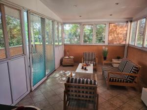 a screened in porch with chairs and a table at Apartment 40 in Zagreb