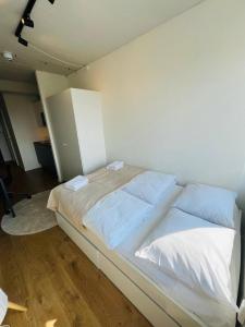 a bedroom with a large bed with white sheets and pillows at Copenhagen Getaway Cute Studio for Two 5 in Copenhagen