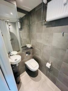 a small bathroom with a toilet and a sink at Copenhagen Getaway Cute Studio for Two 5 in Copenhagen