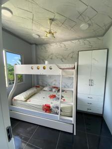 a white bunk bed in a room with a ceiling at Naseema Hiya - Central Ukulhas Residences in Ukulhas