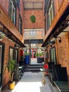 an alleyway between two buildings with tables and chairs at Mit Hotel Tbilisi in Tbilisi City +76 photos