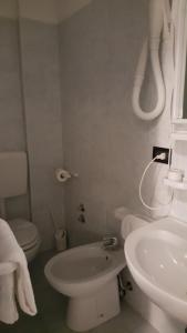 a white bathroom with a sink and a toilet at Hotel San Marco BB in Boario Terme +51 photos