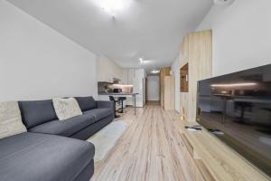 a living room with a couch and a table at 1-bedroom apartment with balcony, Rustaveliho - Rača in Bratislava
