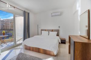 Ένα ή περισσότερα κρεβάτια σε δωμάτιο στο Host Prime Bright Apartment