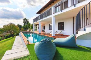 a house with a swimming pool with two large pillows at Welcoming villa with pool & views! - Villa Mirella in Dagnente +51 photos