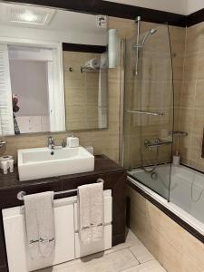 a bathroom with a sink and a shower at Domina Coral Bay Elisir in Sharm El Sheikh