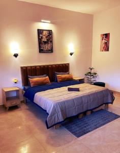 Un dormitorio con una cama grande con una manta azul. en Embassy Loagde Inn, en Mussoorie