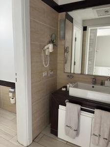 a bathroom with a sink and a mirror at Domina Coral Bay Elisir in Sharm El Sheikh