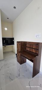 a room with a wooden piano in a room at MMS Residence in Ranipet