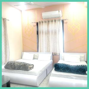 a room with two beds and a window at Hotel Khatoo Shyam House in Khātu