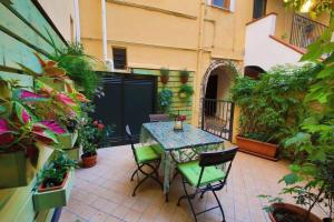 a patio with a table and chairs and plants at Il Vicolo Incantato in Fondi