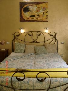 sypialnia z dużym łóżkiem z metalowym zagłówkiem w obiekcie B&B Il Giardinetto Alghero w mieście Alghero