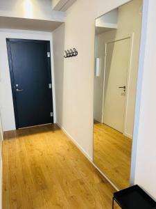an empty room with a black door and a mirror at Copenhagen Studio Double Bed and Kitchen 3 in Copenhagen