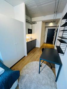 a living room with a black table and a kitchen at Copenhagen Studio Double Bed and Kitchen 3 in Copenhagen