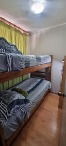 two bunk beds in a room with a window at zpartment in Copiapó