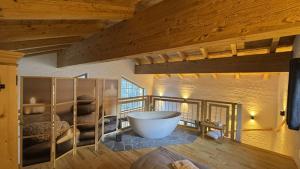 a bathroom with a large tub in a room at Chalet am Bachl 1 in Flattach