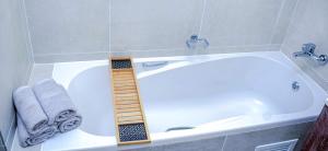 a bathroom with a tub with a ladder in it at Royal Golfview Stay in Boksburg +37 photos