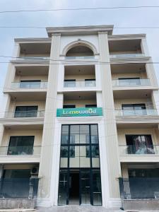 a building with a sign on the front of it at Limewood Signature - Golf Course Road in Gurgaon