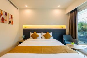 a hotel room with a bed and a window at Limewood Signature - Golf Course Road in Gurgaon