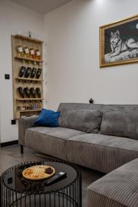 a living room with a couch and a table at The Golden Wolf - Wellnes & Spa Luxury Apartment - SELF CHECK IN - FREE PARKING in Vukovar