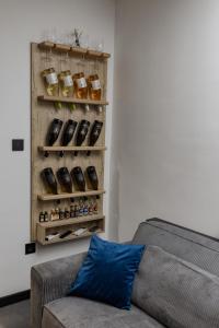 a living room with a couch and a shelf with spices at The Golden Wolf - Wellnes & Spa Luxury Apartment - SELF CHECK IN - FREE PARKING in Vukovar +46 photos