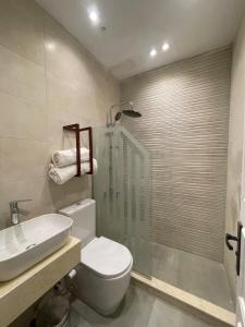 a bathroom with a shower and a toilet and a sink at Modern Boho Chalet in Central Sharm El Sheikh in Sharm El Sheikh
