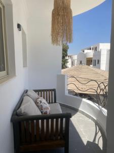 a bench on a balcony with a view of a building at Modern Boho Chalet in Central Sharm El Sheikh in Sharm El Sheikh