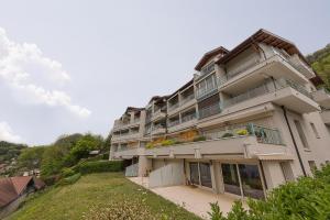 a large building with balconies on a hill at L'Arcadia Panoramique - Terrasse Vue Lac et Piscine in Talloires