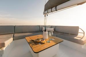 a living room with a couch and a table at Dione Catamaran in Thessaloniki +9 photos
