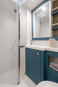 a bathroom with a blue sink and a shower at Dione Catamaran in Thessaloniki