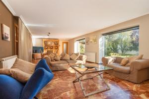 ein Wohnzimmer mit Sofas und einem Glastisch in der Unterkunft Casa Valfonda in Torres de Barbués