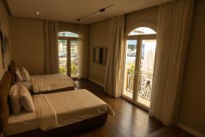 a bedroom with two beds and a balcony at Munir`s residence 3 in Cairo
