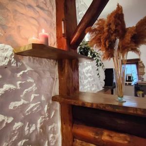 a room with a table with two candles on a wall at La Monta Cosy in Saint-Égrève